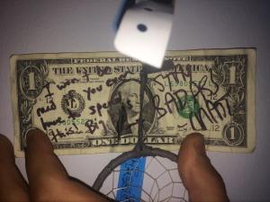 David Malkiewich displays a dollar bill he got signed by Matt and Kim.